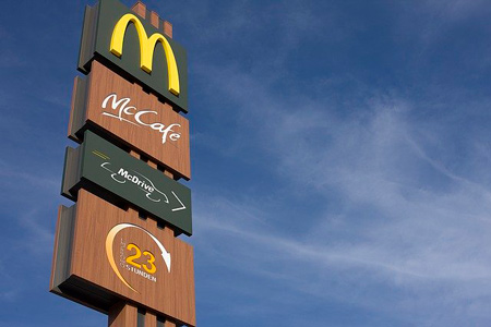 McDonald's logos on the billboard. McDonald's is a good example of successful restaurant business model 